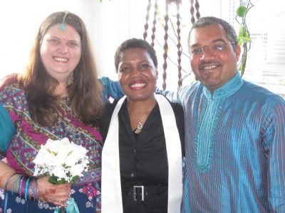 Natalie Tyler smiling with elopement couple in pink & blue clothing